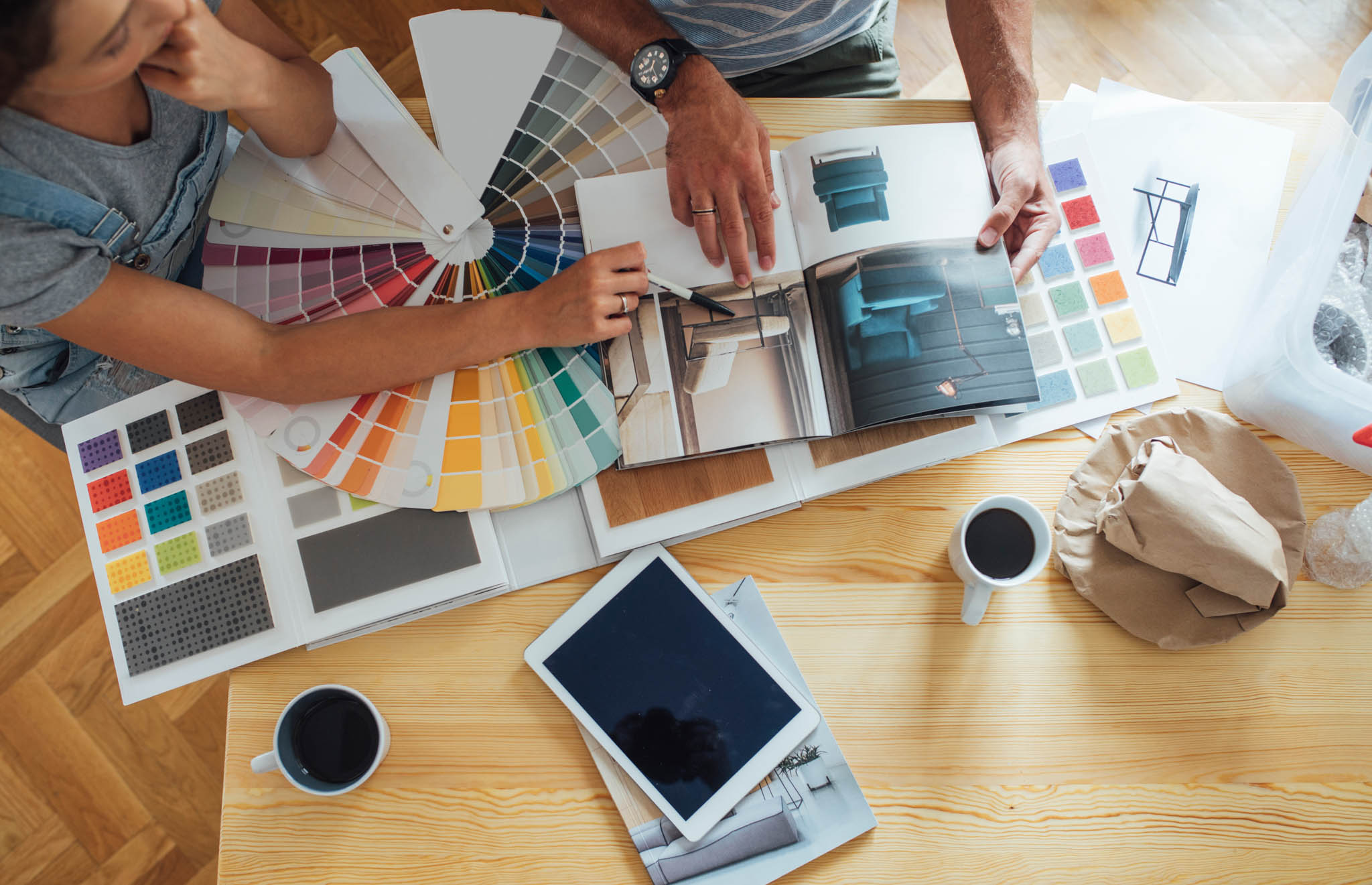 An image of people planning their home renovation project - follow this guide from RiseCon North America so you can prepare for your home remodel!